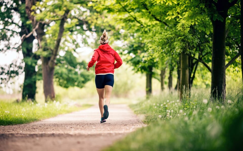 woman running through trees