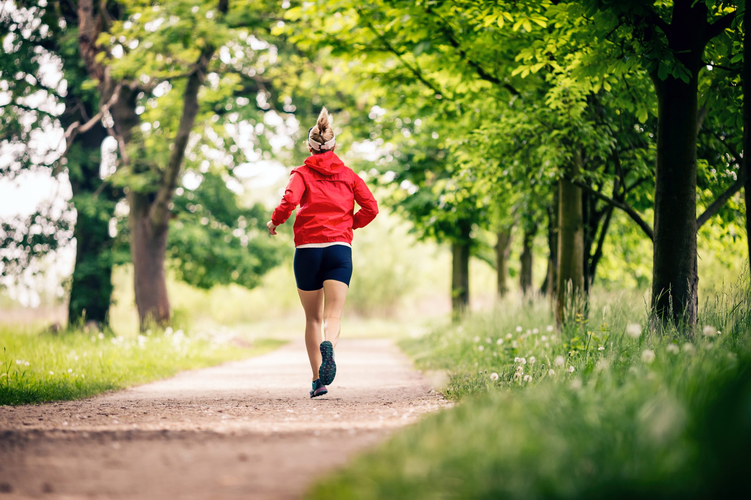 woman running through trees