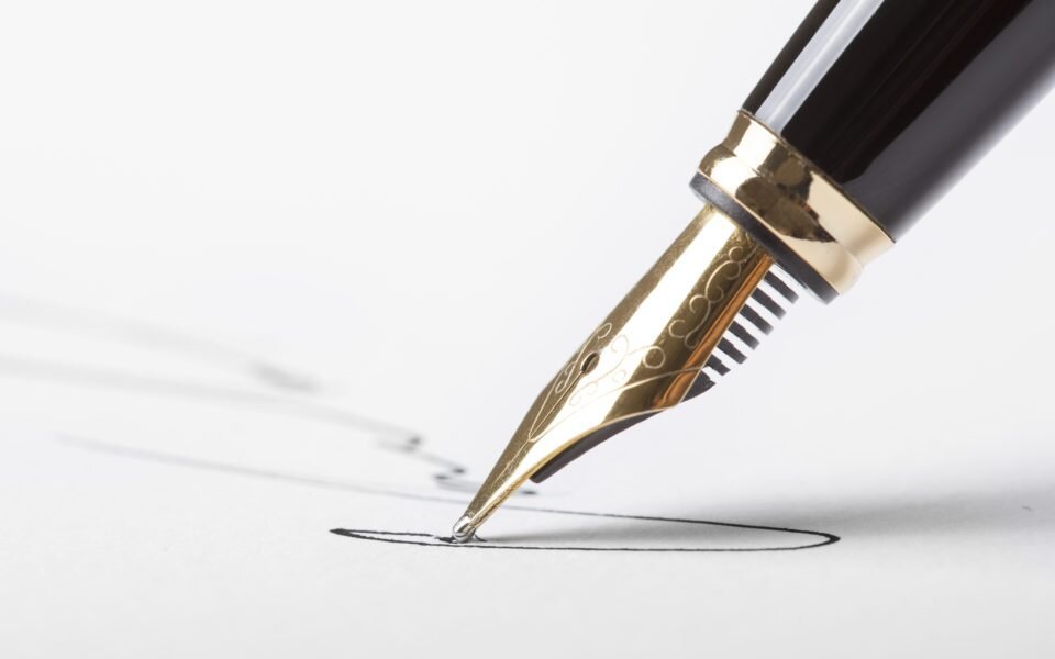 pen signing white paper