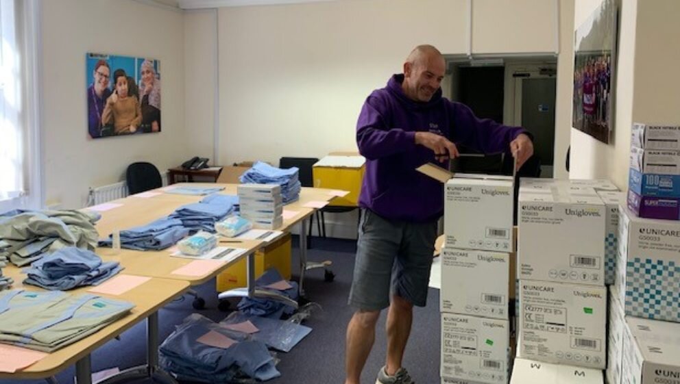 WellChild Staff member packing PPE