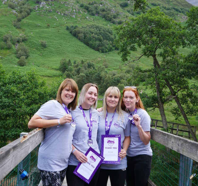 Three Peaks Challenge participants with their medals