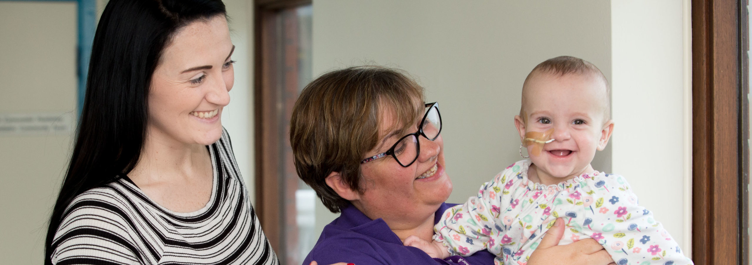 Phoebe and her mum with WellChild Nurse Esther