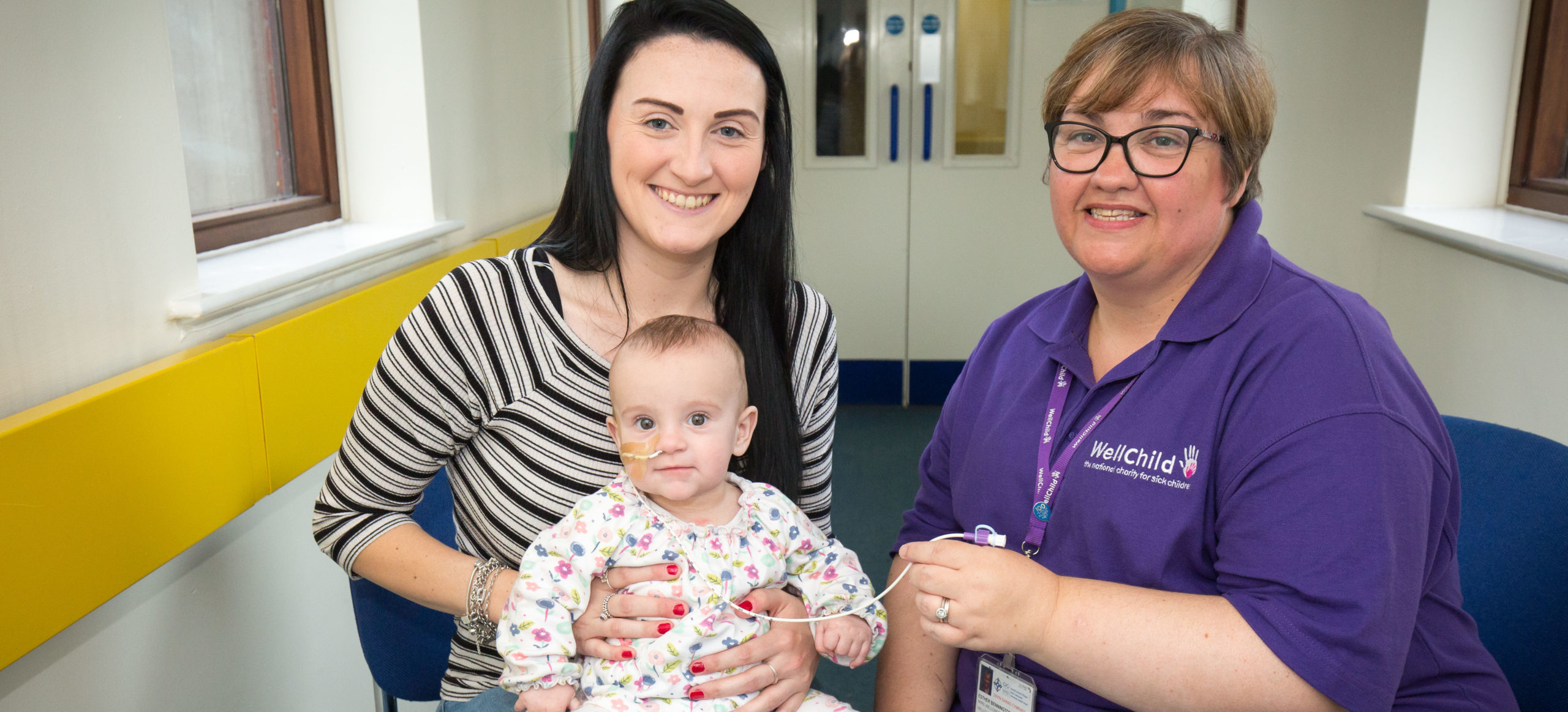 Phoebe and her mum sat with WellChild Nurse Esther