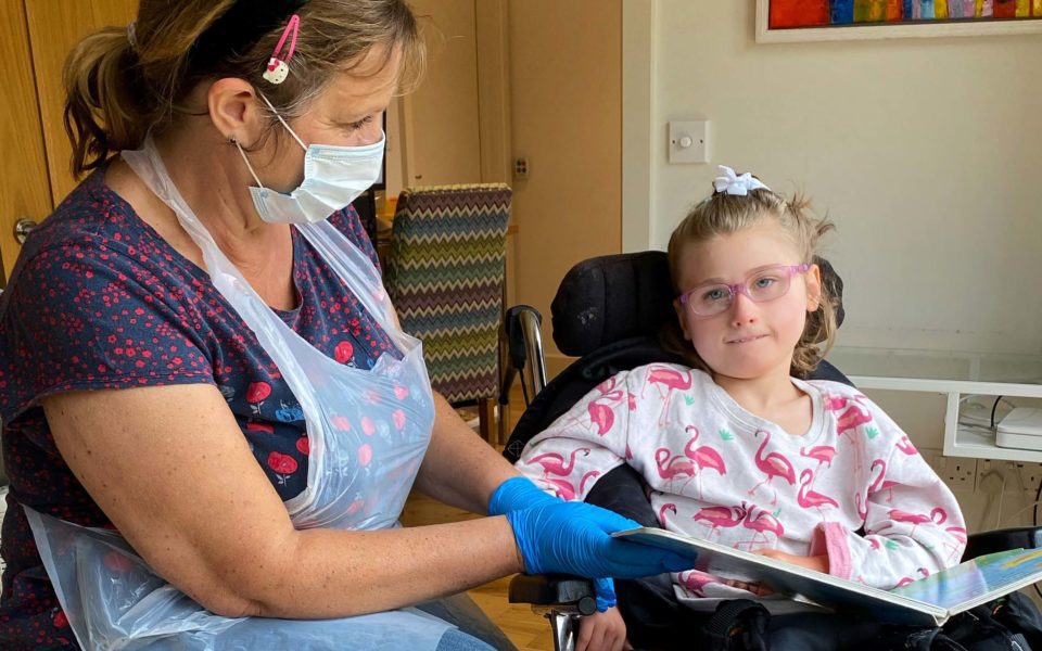 Child and carer receiving PPE from WellChild