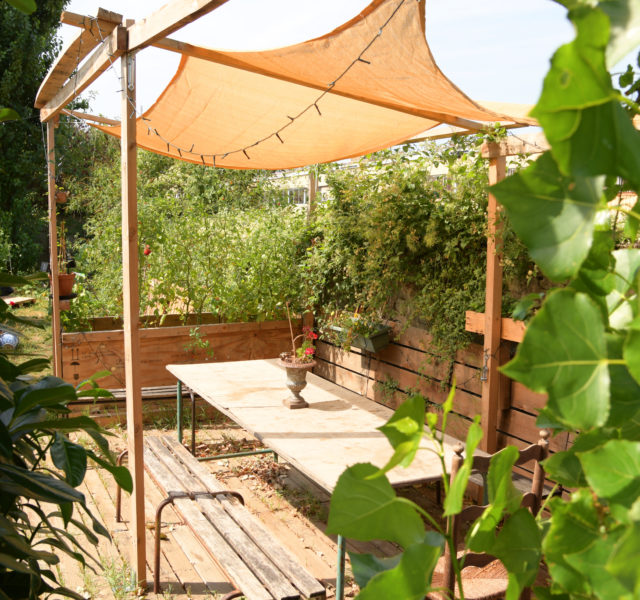 basic pergola with seating in a Mediterranean garden