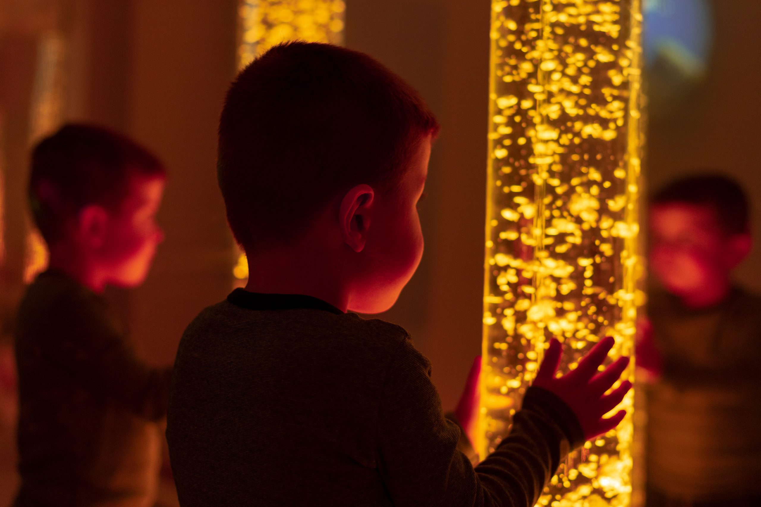 boy looking at a sensory light