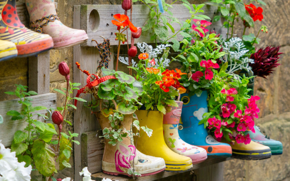 Welly planters hung up on a fence