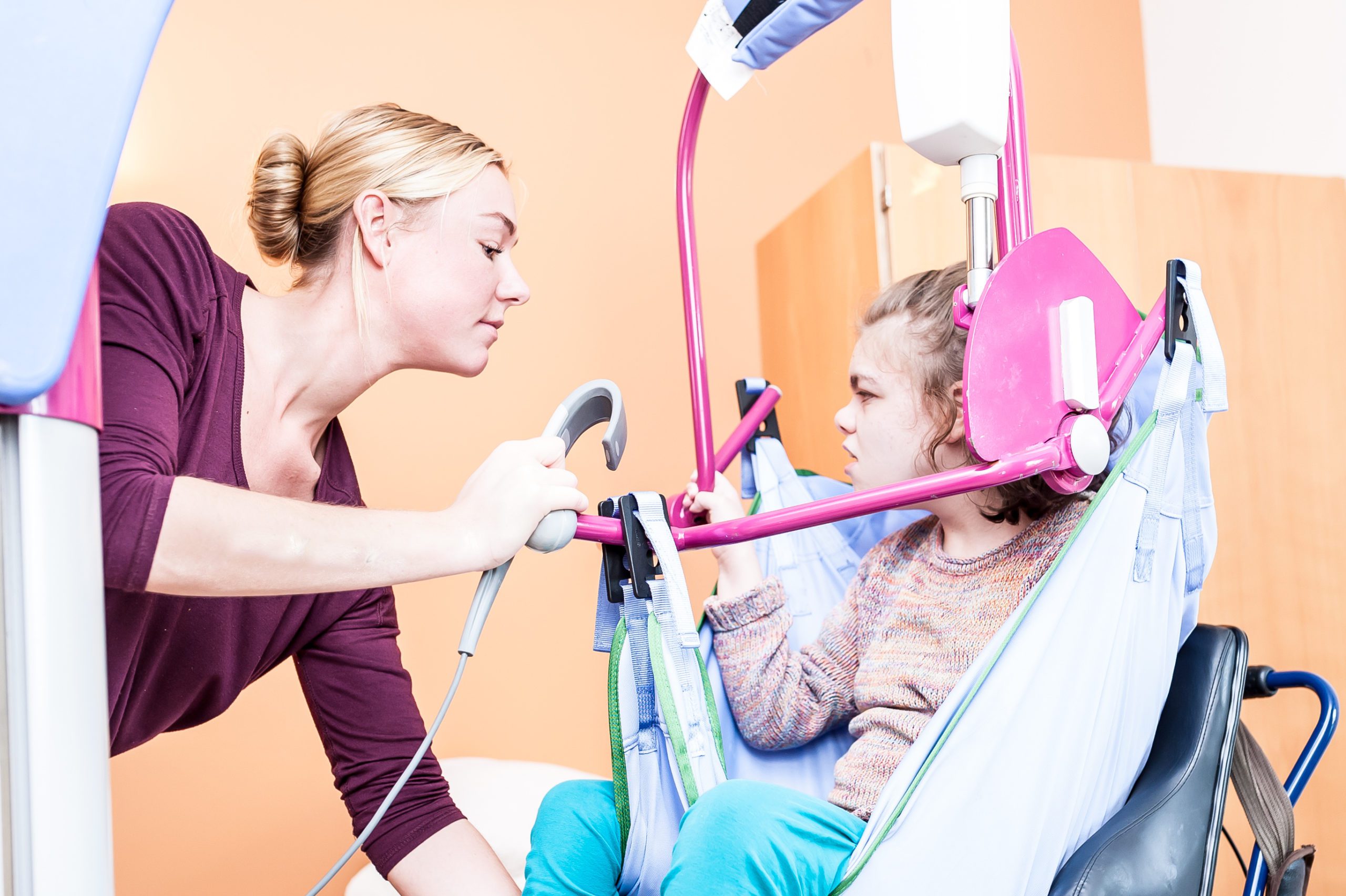 disabled child being lifted by a hoist