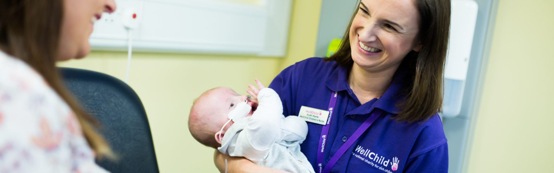 WellChild Nurse Ruth holding baby, Rory