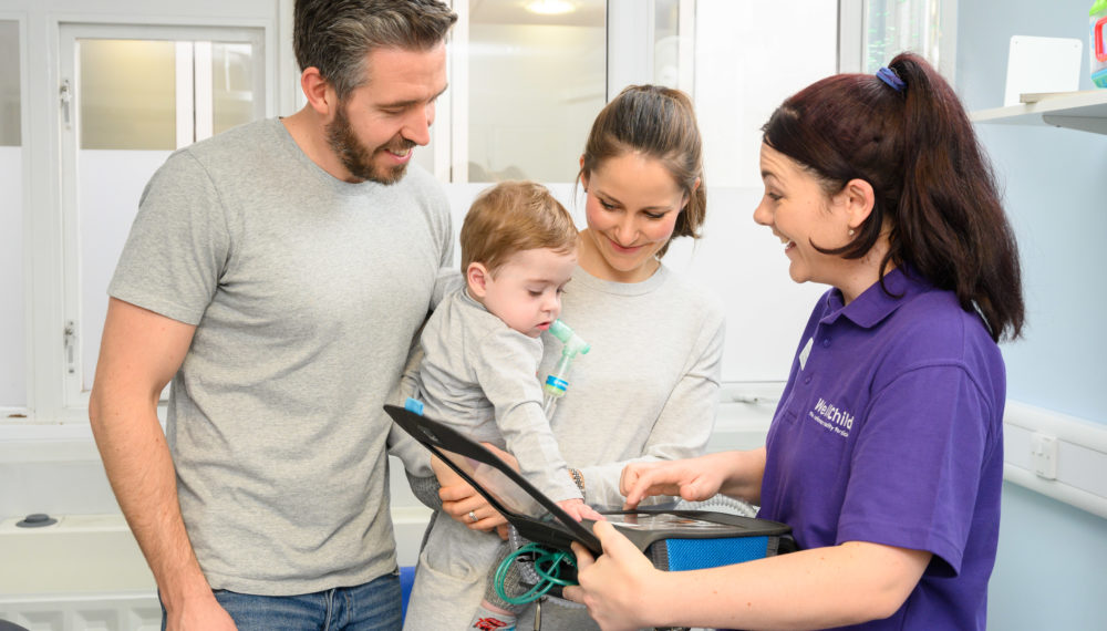 WellChild nurse helping family with their child's ventilator