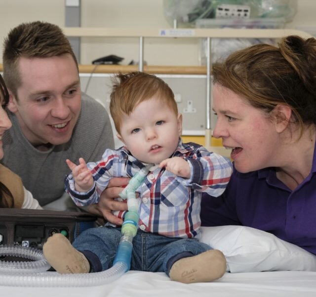 Rogan with his mum, dad and WellChild Nurse Linda