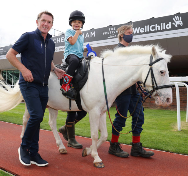 AP McCoy with young boy sat on a pony