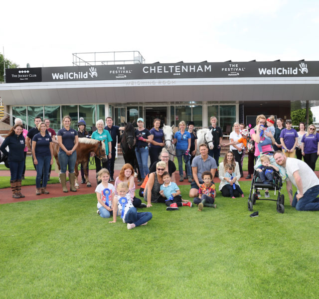 Group photo of attendees of Giddy Up For Good event at Cheltenham Racecourse