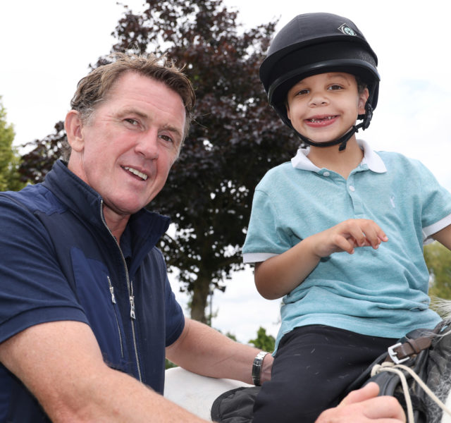 AP McCoy with young boy horse riding