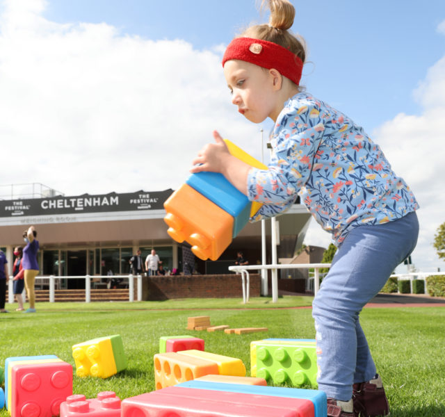 Young girl playing with giant lego bricks