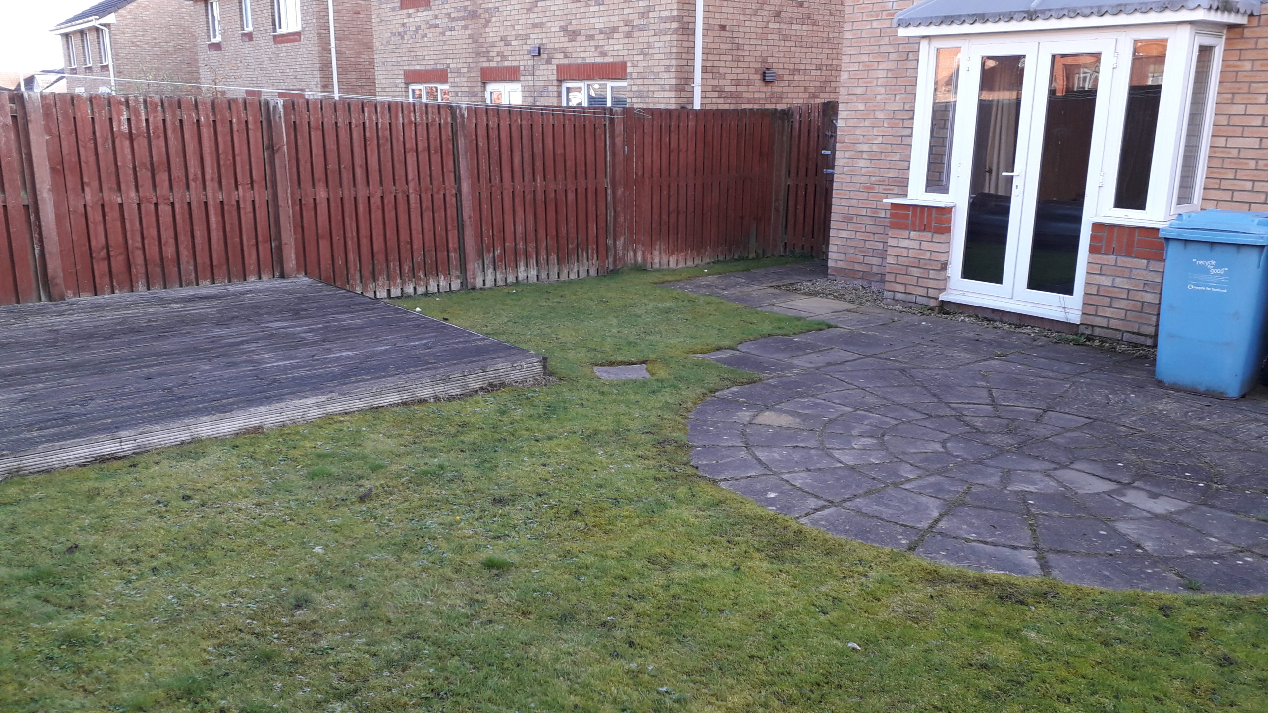 Garden with concrete slabs and boggy grass